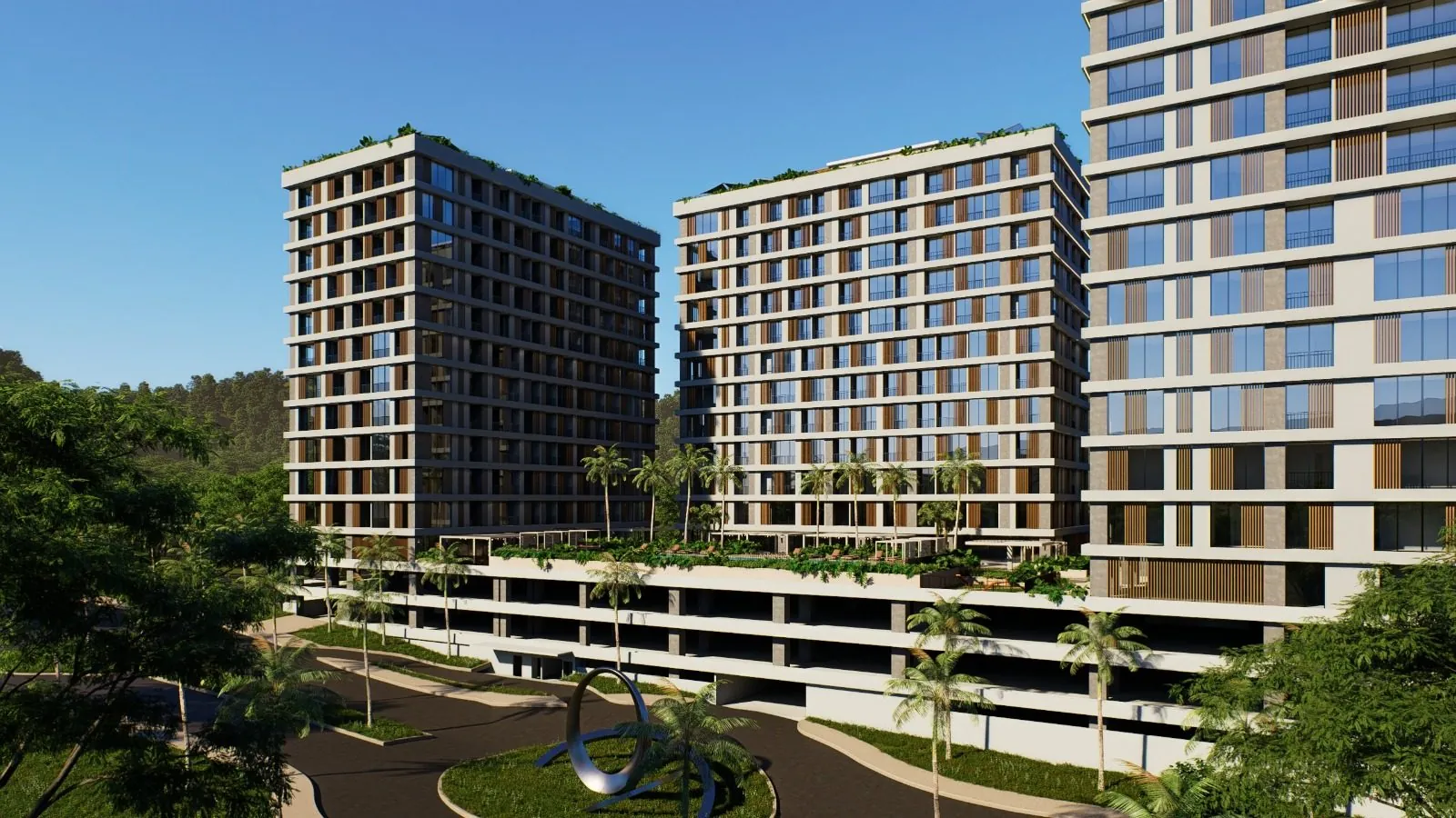 Ingreso a Maya Residences con glorieta y escultura